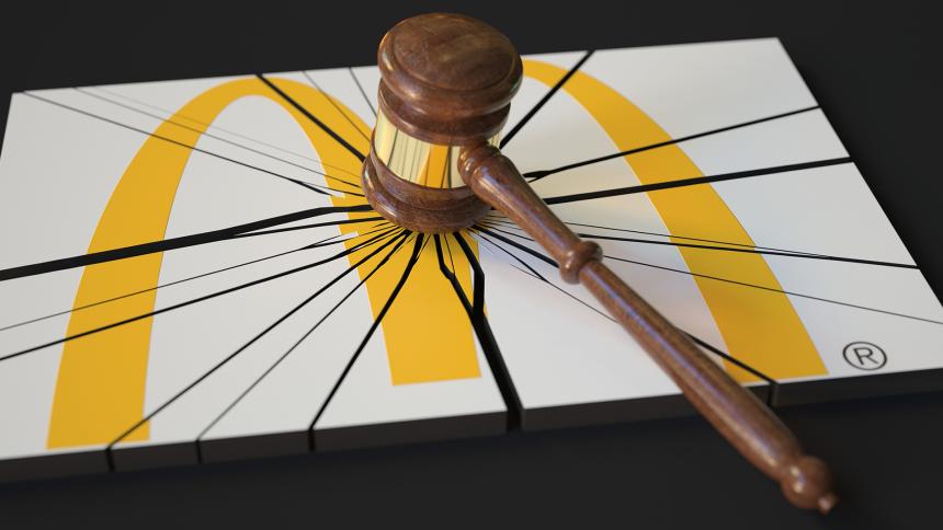 A judge's gavel smashes the McDonald's logo