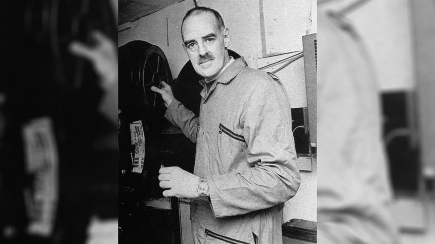 Peter Moore in the projection room of a movie theatre