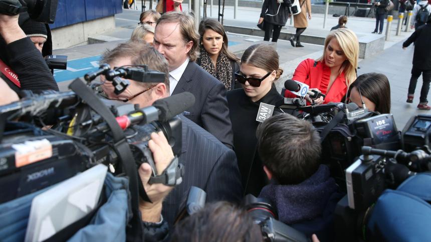 Belle Gibson is swarmed by cameras as she leaves court