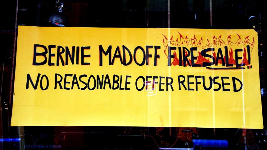 Sign in the window of a guitar shop that reads 'Bernie Madoff Firesale! No reasonable offer refused'