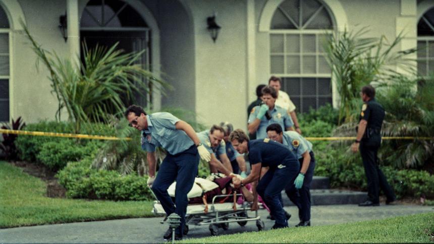 Paramedics wheel Marlene Warren to an ambulance after she was shot on her doorstep