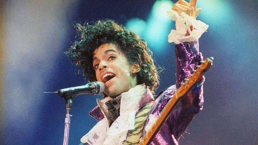 Prince wears a sparkly purple jacket as he performs in 1985