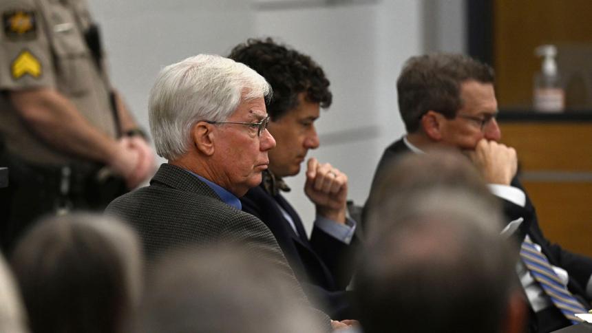 Thomas Martens sitting with his attorneys in court