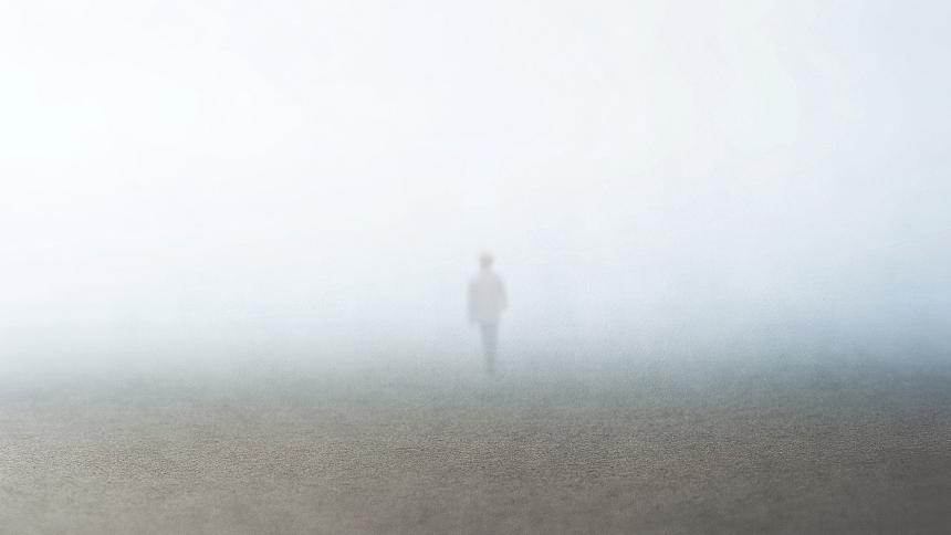 The faint outline of a person disappearing into a foggy mist