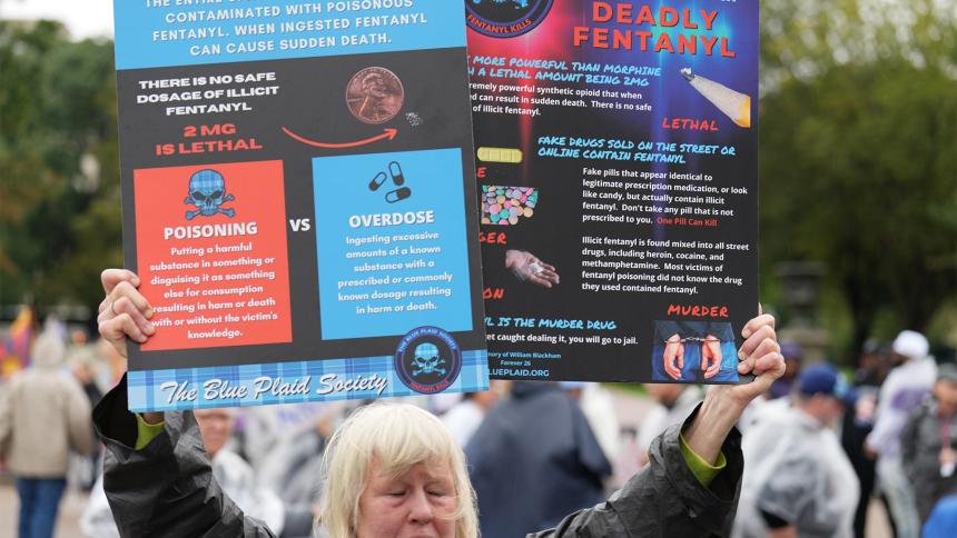A woman holds up a sign outlining the dangers of fentanyl in Washington DC