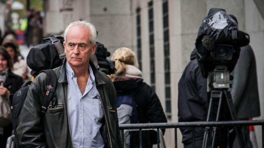 Nick Davies arrives at the Old Bailey court in London - surrounded by news cameras