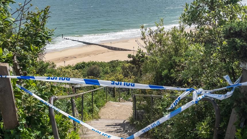 Police tape blocking off the steps down to Durley Chine Beach