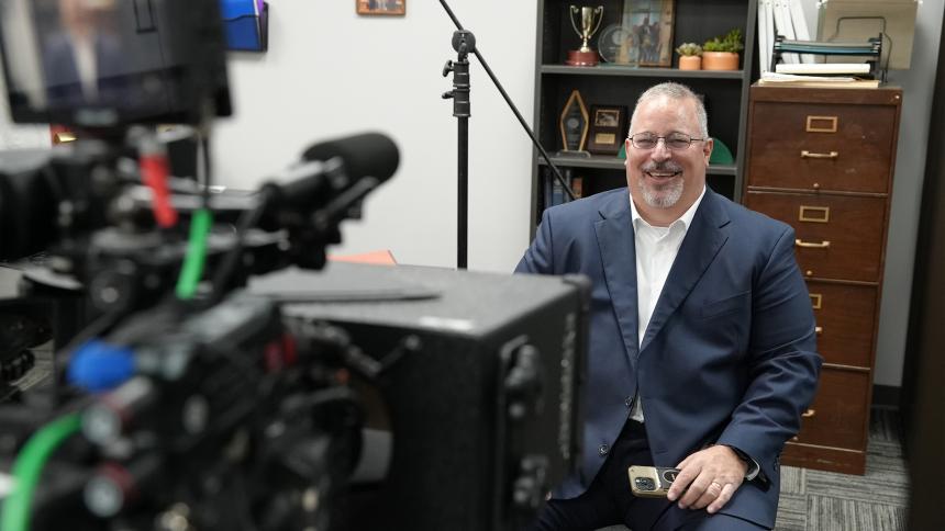Tony Godwin smiles as he sits in front of a camera about to do an interview for Predator Hunters