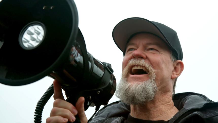 Flash Shelton uses a megaphone