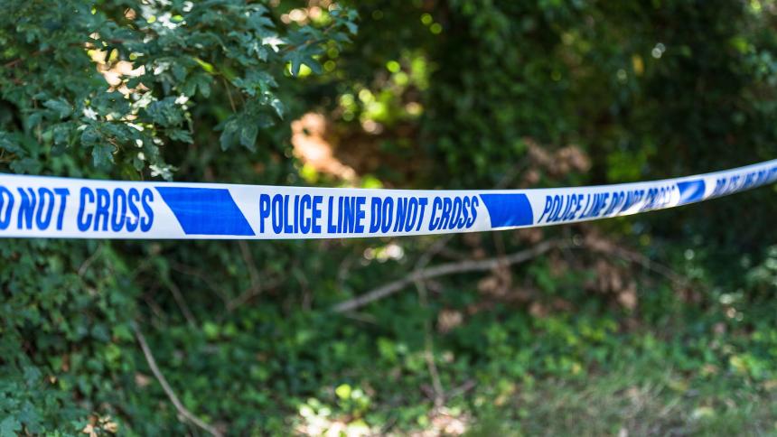 Police tape in a park