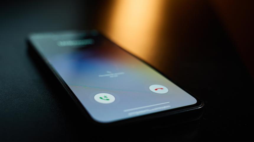 A smartphone lighting up as it receives a phone call
