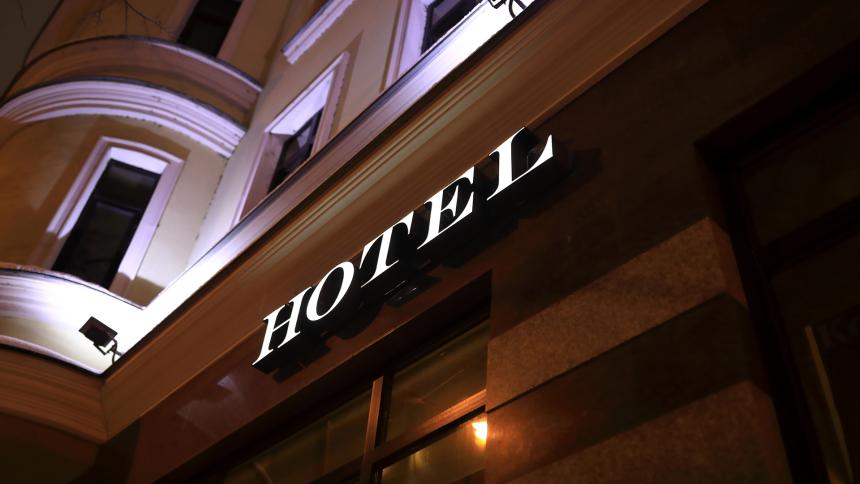 A sign outside a hotel at night