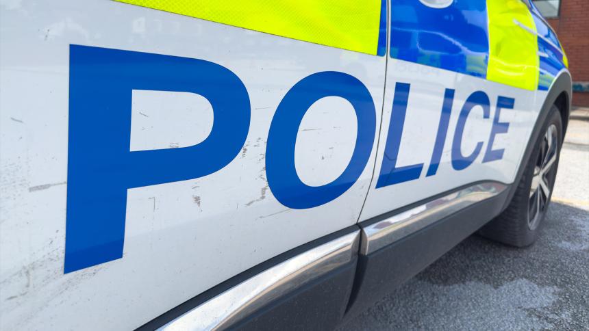The word 'Police' written on the side of a police car