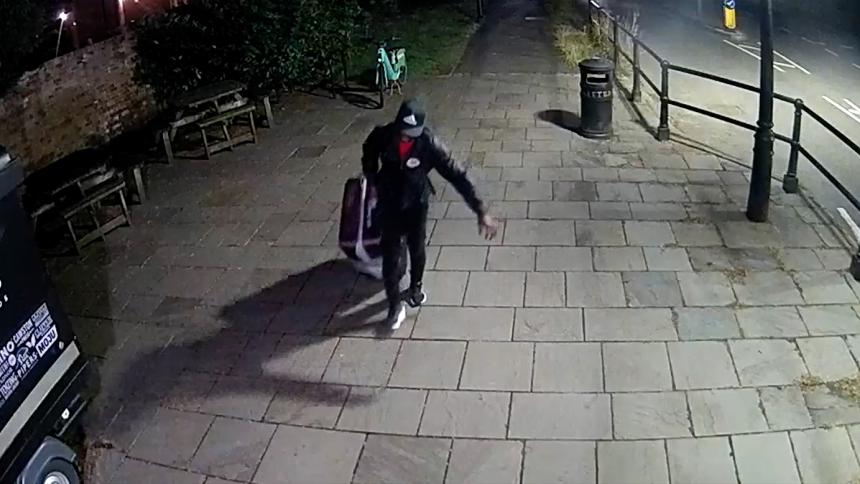 CCTV of Yostin Andres Mosquera wheeling a suitcase across the bridge