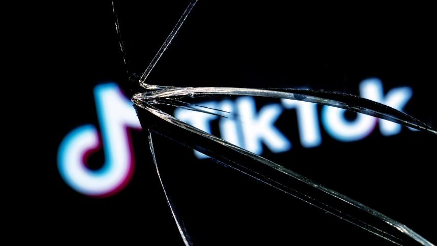 The TikTok logo in the reflection of a broken mirror